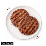 Two grilled hamburger patties on a white plate with 'Prime Range Fresh' branding.