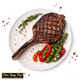 Grilled Tomahawk Steak with vegetables on a white plate, featuring Prime Range Fresh branding.